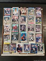 Top view of various baseball cards arranged in rows showing player images and set identification