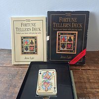 The set containing the deck of custom fortune telling playing cards and two books by Jane Lyle.