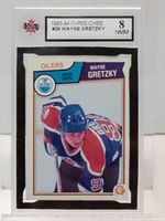 Front of the 1983-84 O-Pee-Chee Wayne Gretzky hockey card graded 8 NMM by KSA, showing Gretzky in Oilers uniform.