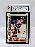 Front of graded 1986-87 Topps Wayne Gretzky hockey sticker showing player image, All-Star designation, and grade 5 label.