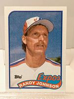 Front of Randy Johnson 1989 Topps rookie baseball card with player photo and team logo.