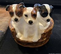 Front view showing three Jack Russell puppies in a basket with detailed painting and glossy finish.