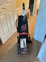 Full front view of Bissell ProHeat Pet 2 carpet cleaner showing overall condition, controls, and branding.