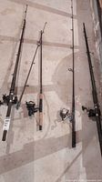 Four fishing rods laid out on floor showing length and design difference