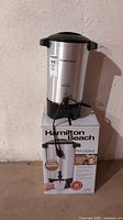 Front view of Hamilton Beach stainless steel coffee percolator sitting on original box.