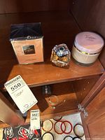 Full set of Lancôme Tresor items including sealed boxed perfume, opened perfume bottle, and body cream jar on wooden shelf