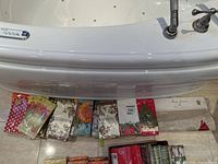 Various packs of decorative paper napkins arranged on a surface near a bath edge.