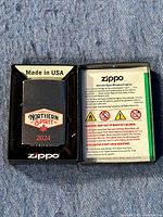 Top view of the Zippo lighter in original packaging showing Northern Spirits Cigarettes 2024 logo and Made in USA insert.