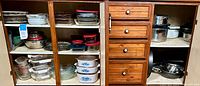 Kitchen cabinet with CorningWare dishes, glass bowls, and plastic food storage containers on shelves