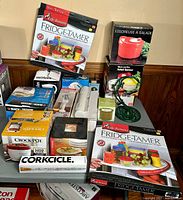 Wide view of all boxed kitchen items showing brands and condition