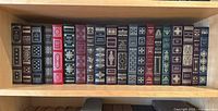 One shelf of 18 leatherbound books in full view