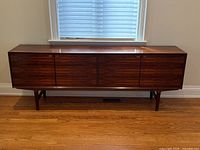 Front view of credenza showing four-door layout and leg design