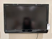 Front view of Sharp Aquos 30 inch LCD HDTV, black frame, clean screen showing subtle reflections.