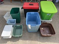 Overview photo showing 11 assorted plastic bins and trash cans in various sizes and colors including blue, green, brown, black, white and red.