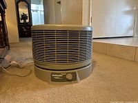 Front angle view of the Honeywell air filter showing the grille and adjustable dial control with power cord.