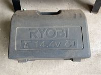 Closed Ryobi branded plastic carrying case indicating 14.4v power tools inside