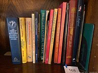 Shelf of vintage books showing a variety of titles related to medical guides, natural medicine, and travel from the seller's lot