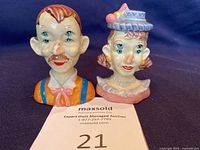 Front view of male and female ceramic figurine salt and pepper shakers with four eyes each, hand-painted in colorful circus style.