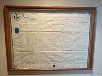 Framed antique indenture document showing full text on parchment with original seal attached at bottom.