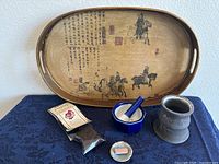 Photo showing the full lot with all items together: wooden tray, mortar and pestle, gray vessel, incense holder and cones, packet of incense.