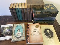 Wide view of 14 vintage books including Little Women, Lakeside Press series, Muir Woods Meditations and others