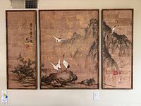 Full frontal view showing all three panels of the tryptich with cranes, bamboo, and mountain landscape artwork hung on a wall.