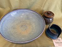 Set of vintage glazed stoneware including a large blue glaze on brown stoneware bowl, blue glazed sugar bowl with lid, and blue glazed sponge holder