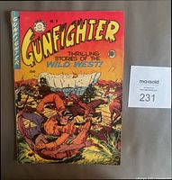 Front cover of the Gunfighter comic book showing Wild West battle scene, vibrant colors, minor edge wear, spine tear and pencil writing.
