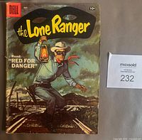 Front cover of 1957 Dell Comics The Lone Ranger #107 showing the main character holding a lantern and the title in yellow on black background.