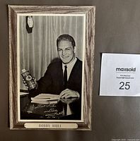 Front photo showing black and white image of Bobby Hull holding Beehive syrup can, framed in faux wood grain print with printed autograph.