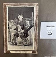 Front view of the Johnny Bower hockey photo mounted on a wood-themed frame.