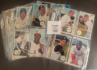 Display of partial set of 1964 Topps Giant Baseball Cards in protective sleeves, showing front sides with player portraits.