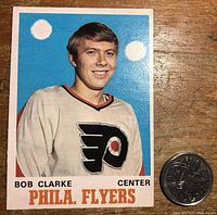 Front of 1970-71 OPC Bobby Clarke rookie card showing player's image and team name.