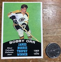 Front of the hockey card showing Bobby Orr in Boston Bruins uniform with green background and trophy winner text.