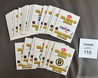 Top view displaying 28 colorful, unopened Post NHL Stars in Action standup cards fanned out showing front logos and titles for multiple NHL teams including Bruins and Capitals.