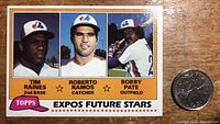 Front of the 1981 Topps Baseball card #479 showing the Expos Future Stars including Tim Raines, Roberto Ramos, and Bobby Pate with a quarter for size comparison.