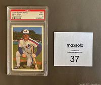Front of the 1986 Topps Pete Rose Expos baseball card #51 showing Pete Rose kneeling with bat, encased in PSA slab graded MINT 9.