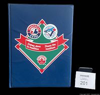 Front cover of the custom blue binder with Montreal Expos and Toronto Blue Jays logos and 'Share the tradition' slogan