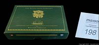 Closed green Upper Deck collector box with gold foil detailing on black background