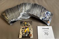 Full view of large fan of 1997 Pinnacle Certified NFL football trading cards spread out showing the edges and multiple cards in the complete set.