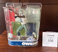 Front of sealed Terrell Owens NFL figurine in Dallas Cowboys uniform showing full packaging and figure details.