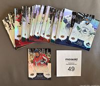 Complete set of hockey cards spread out showing variety and condition of cards.