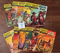 Lot of 10 Classics Illustrated comic books arranged on the floor showing different titles and colorful covers.