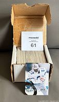 Open cardboard box filled with neatly arranged football cards from the 1994 Pinnacle Select NFL set.