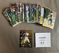 Display of multiple football cards laid out showing front sides of cards fanned in partial arc with one card prominently featuring Jets player Keyshawn Johnson.