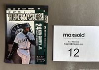 Front side of the 1998 Leaf Ticket Masters insert card showing Ken Griffey Jr. in Seattle Mariners uniform holding a bat, stats on the back.