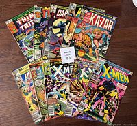 Full lot of 10 Marvel comic books laid out, showing title and cover art for each issue including The Thing, Ka-Zar, Uncanny X-Men, and Daredevil.