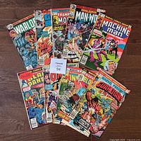 Lot of 10 different Marvel comic books arranged on wooden floor showing front covers including Warlock, Ghost Rider, Frankenstein Monster, Man-Wolf, Machine Man, Black Panther, Omega the Unknown, The Invaders, Bloodstone, and Guardians of the Galaxy.