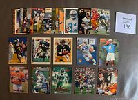 Photo showing full set of 20 NFL rookie cards laid out on a surface, featuring notable players such as Brett Favre and Drew Bledsoe with visible team colors and logos.