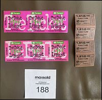 Two blocks of six unused OC Transpo transit tickets ($1.65 each) and a block of unused Montreal transit tickets priced at 1.91$ each for 5 tickets, all unused, laid flat on grey surface with MaxSold number